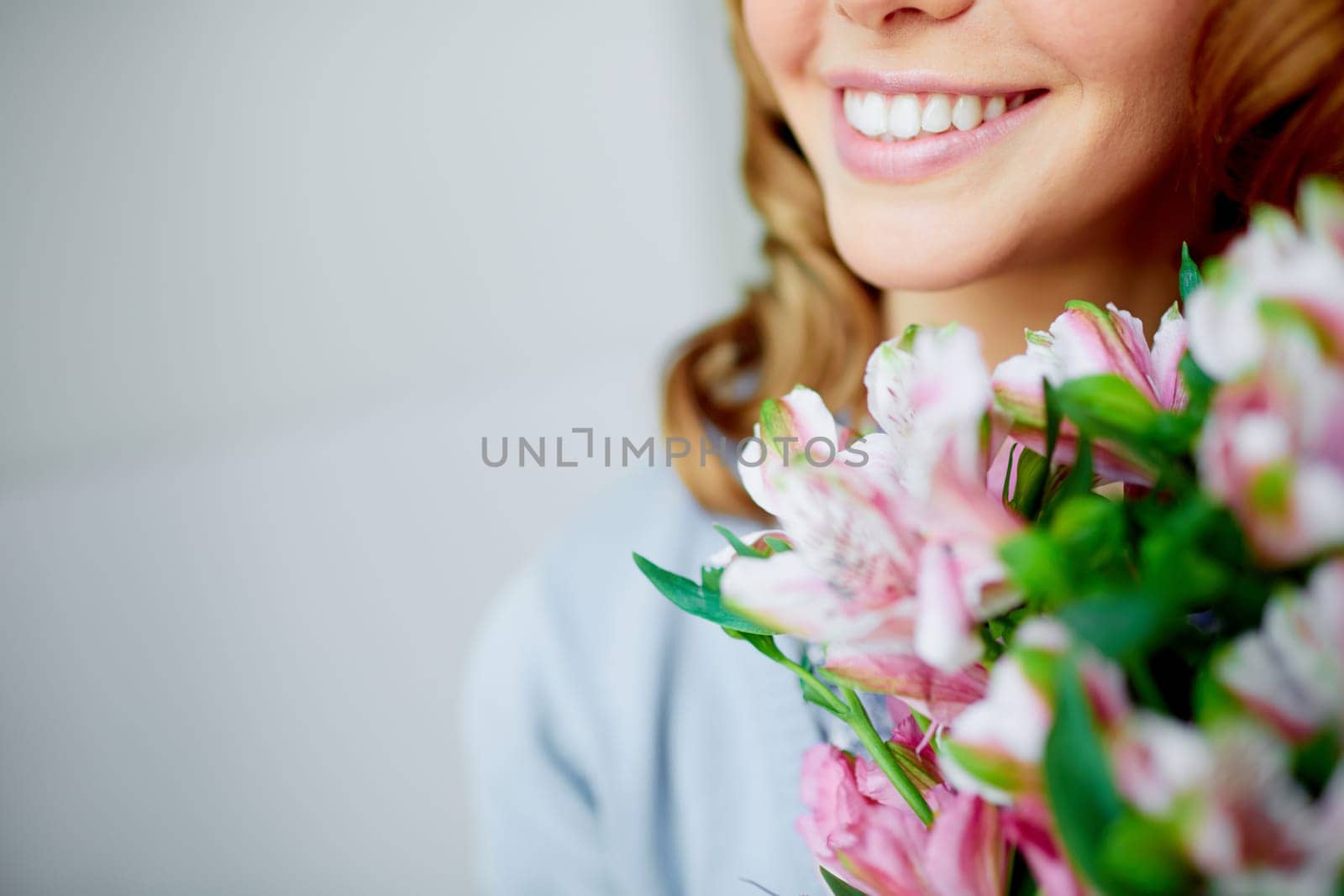 Bunch of fresh flowers held by smiling female