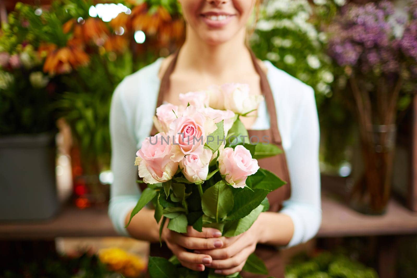 Female holding bunch of pale roses