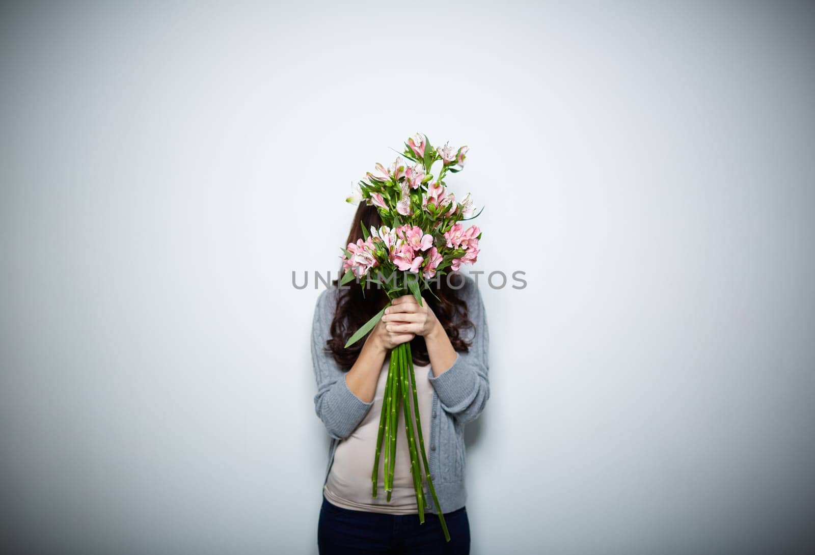 Young woman behind big bouquet