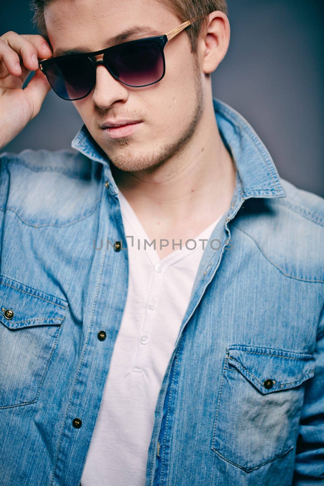 Portrait of a young stylish man in sunglasses