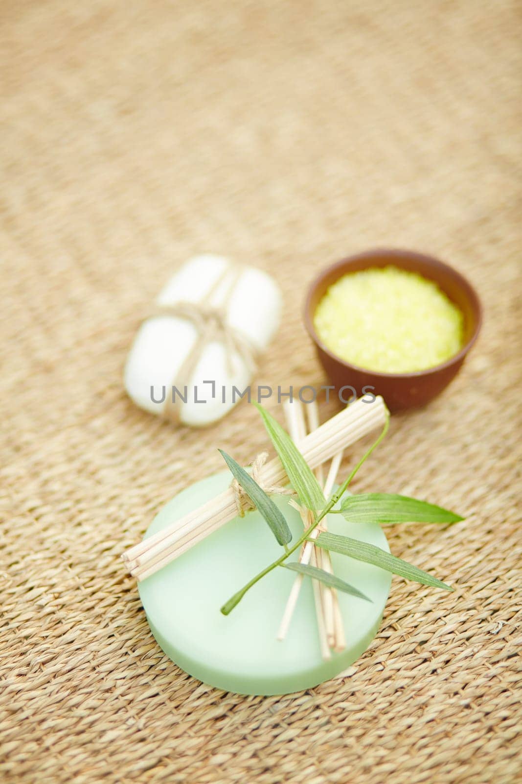 Toilet soap, bath salt and cosmetic sticks on wattled rug