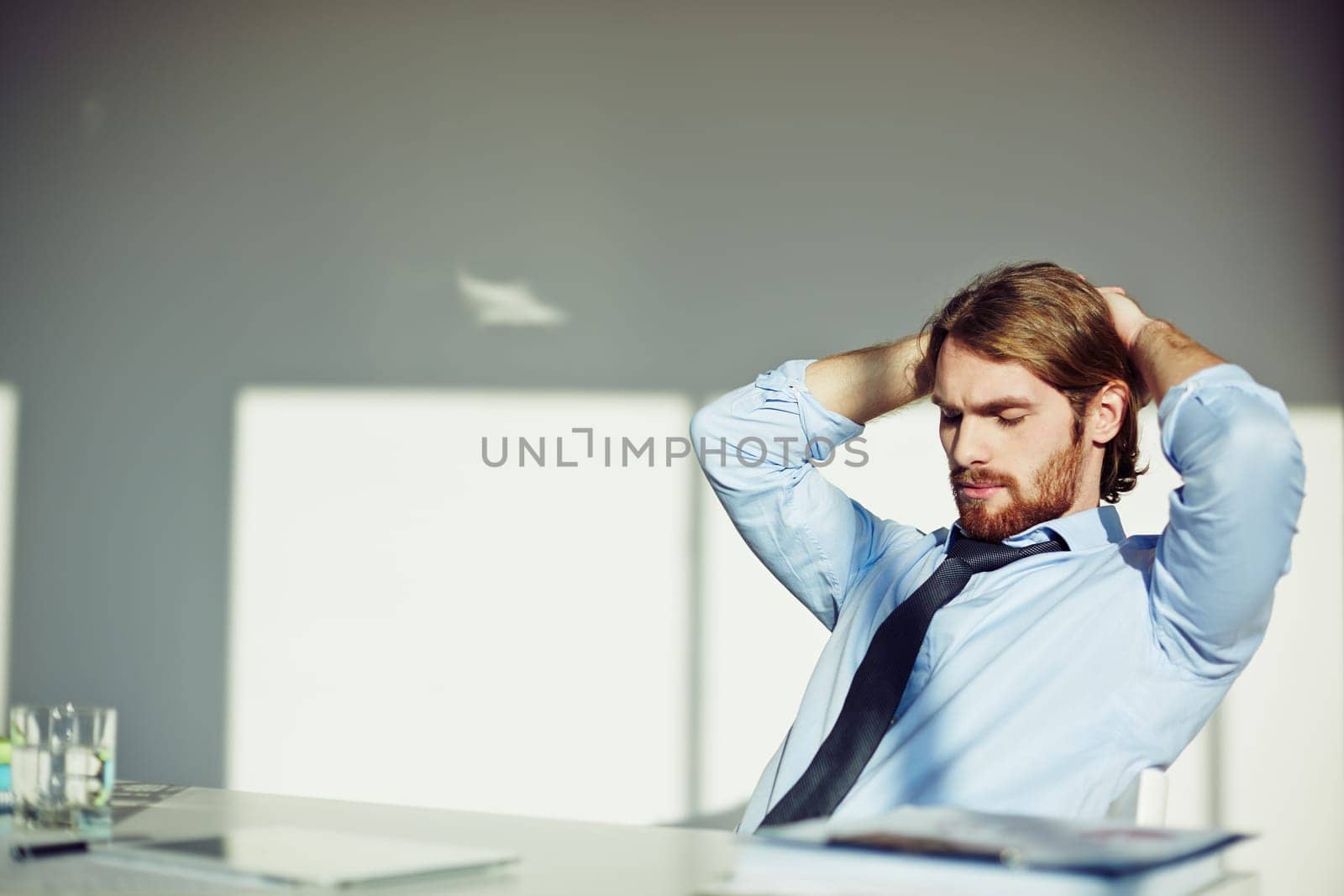 Office worker taking a pause at his workplace