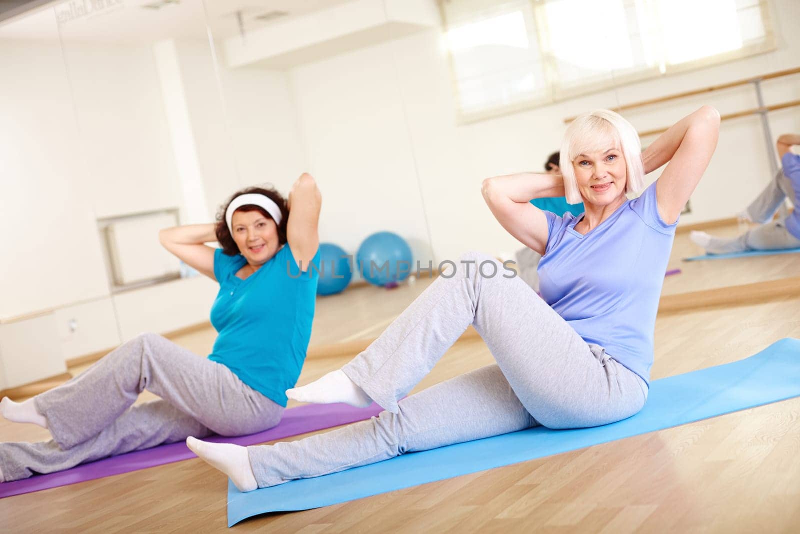 Portrait of sporty females doing physical exercise in sport gym