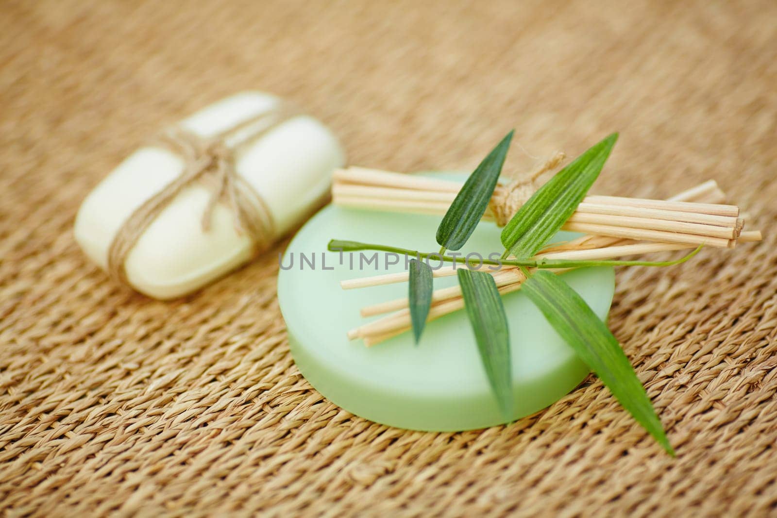 Toilet soap and wooden cosmetic sticks on wattled rug