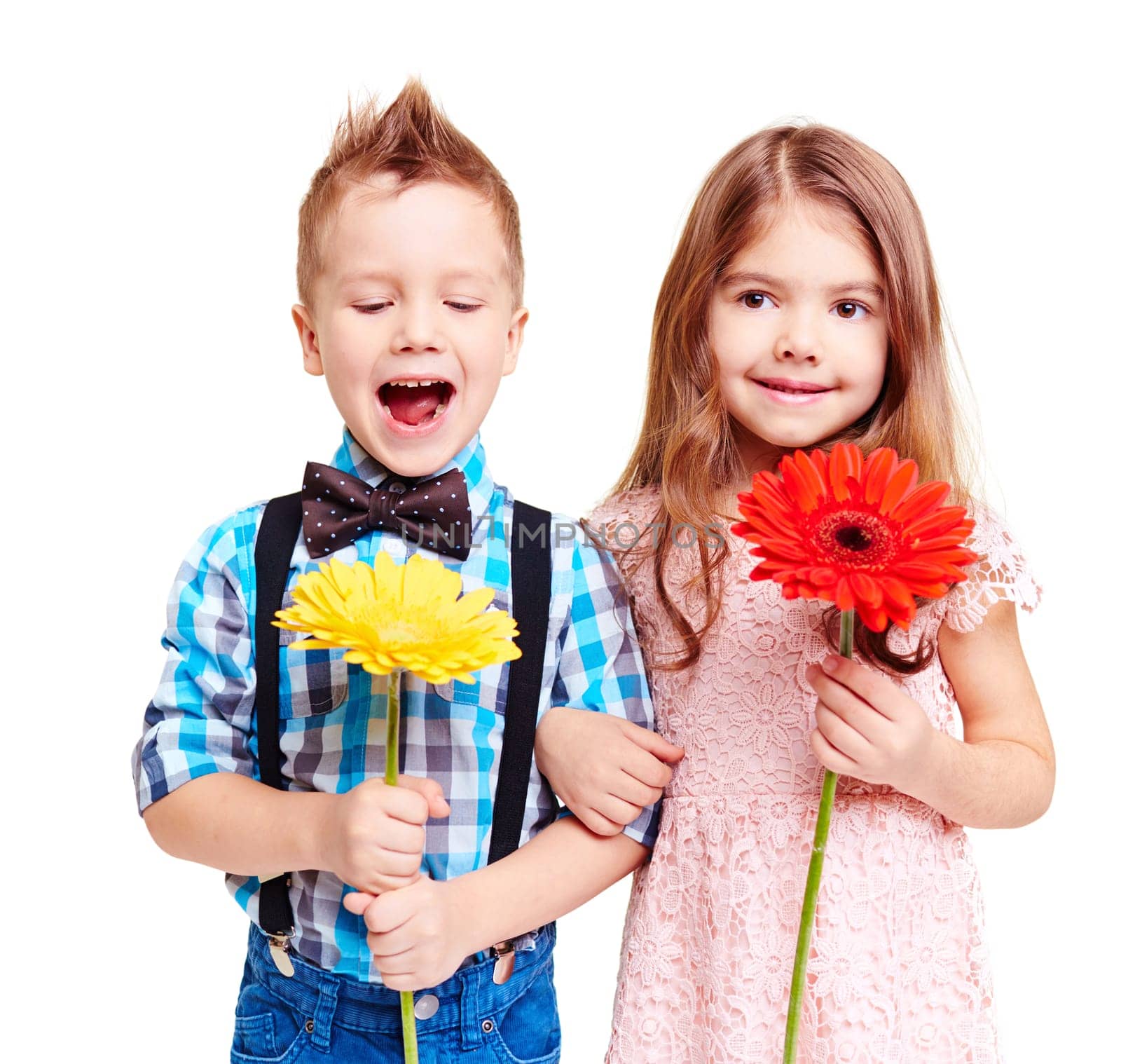 Portrait of cute couple of children with flowers in hands