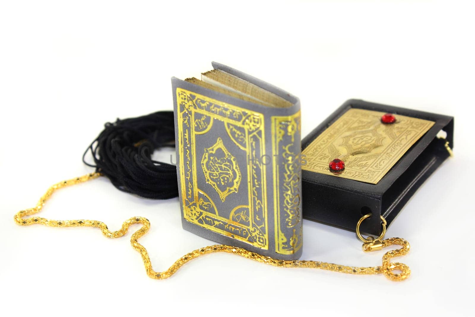 a Koran with a cover and chain