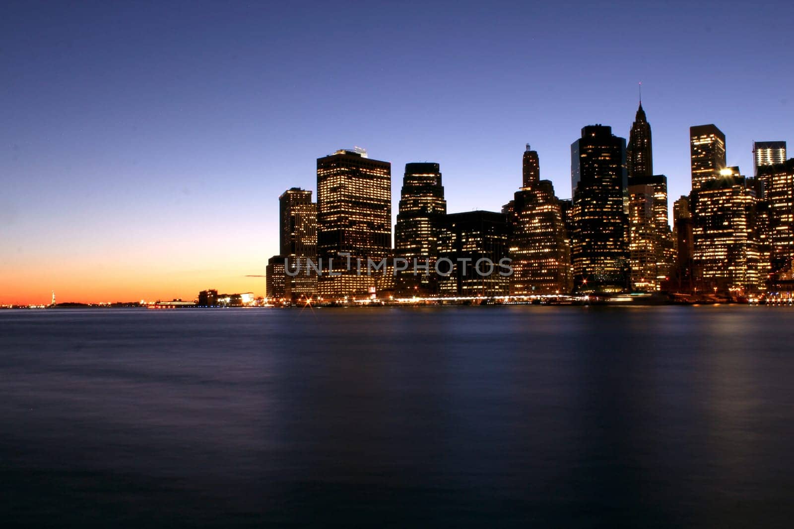 Twilight as the sun sets over Lower Manhattan. Famous New York landmarks.