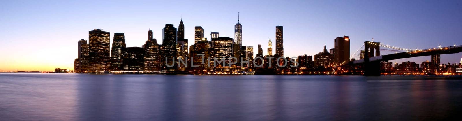 Twilight as the sun sets over Lower Manhattan. Famous New York landmarks.