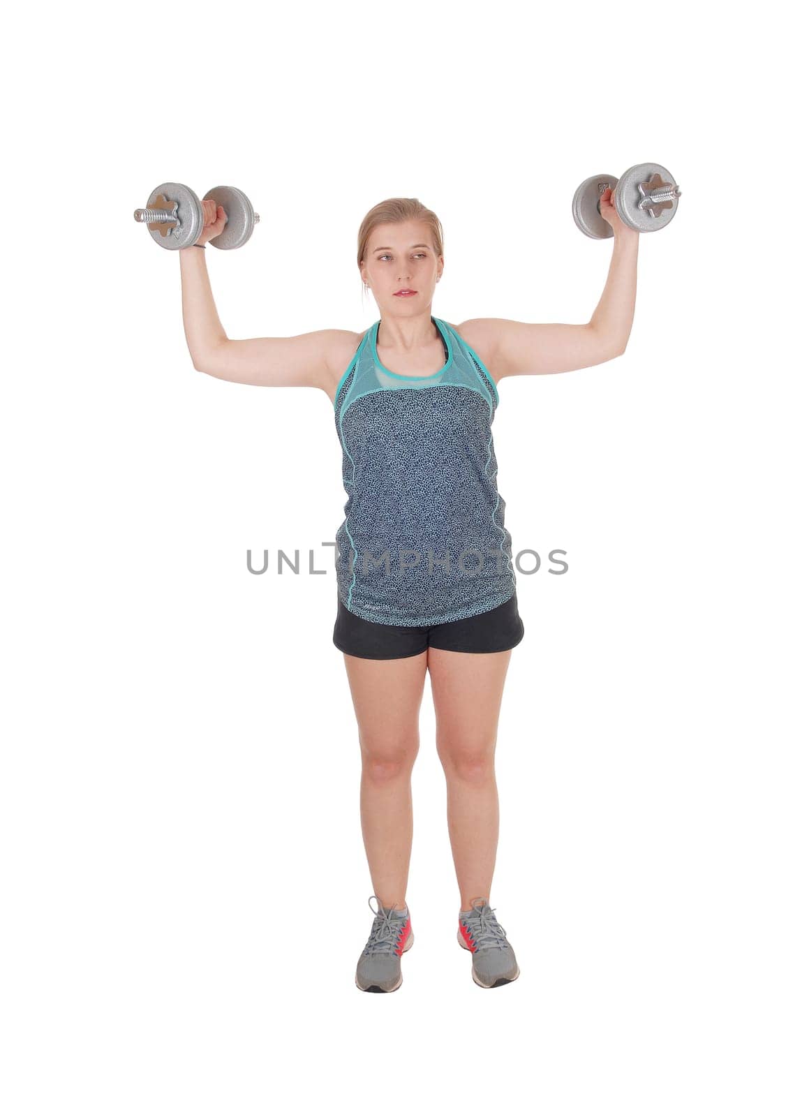 A fit young slim woman standing isolated for white background and.lifting two dumbbell's up to exercise her strength.