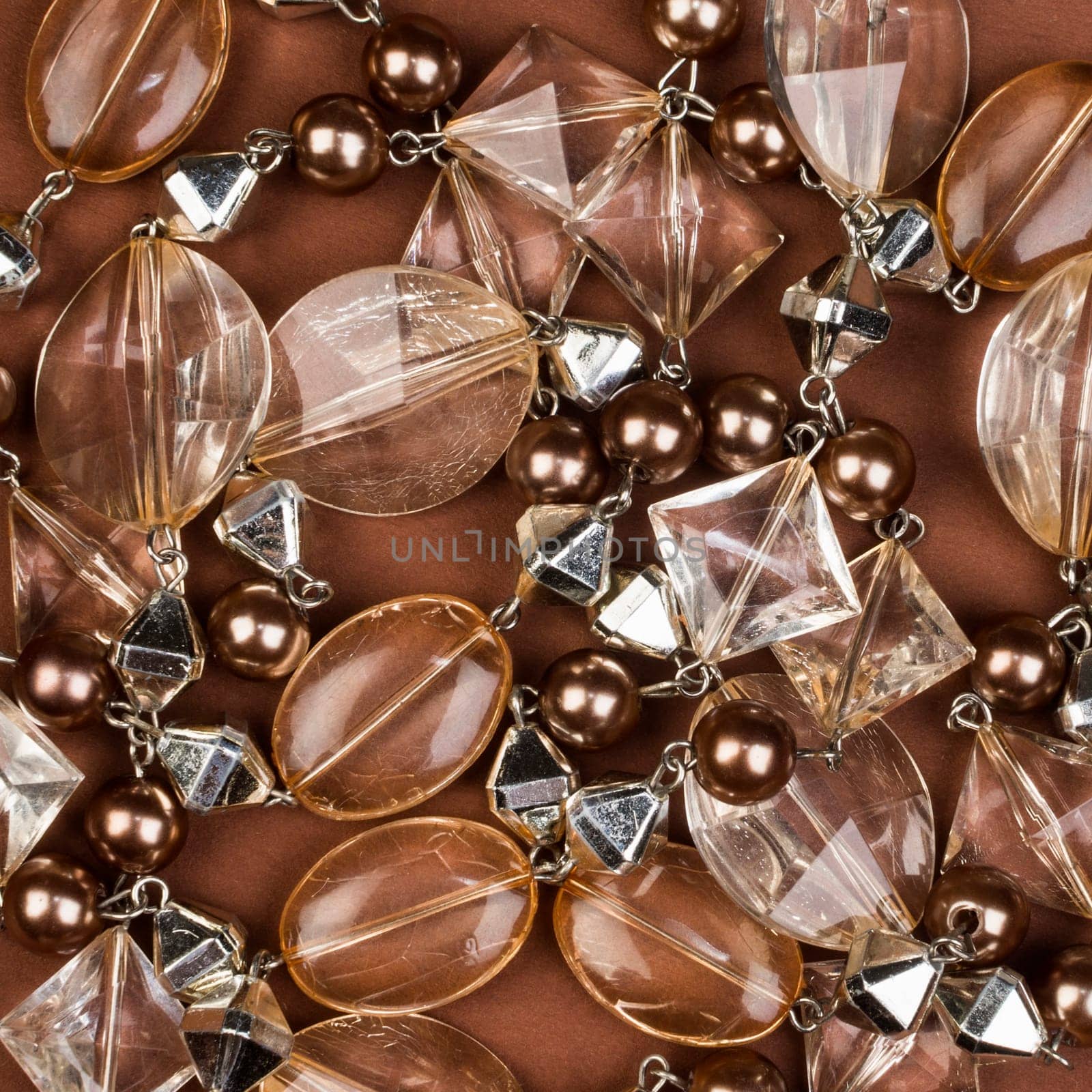 Transparent brown jewel texture on brown background.