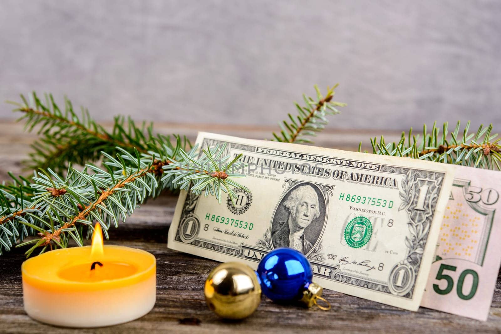 christmas sill with money, fir branch and candle