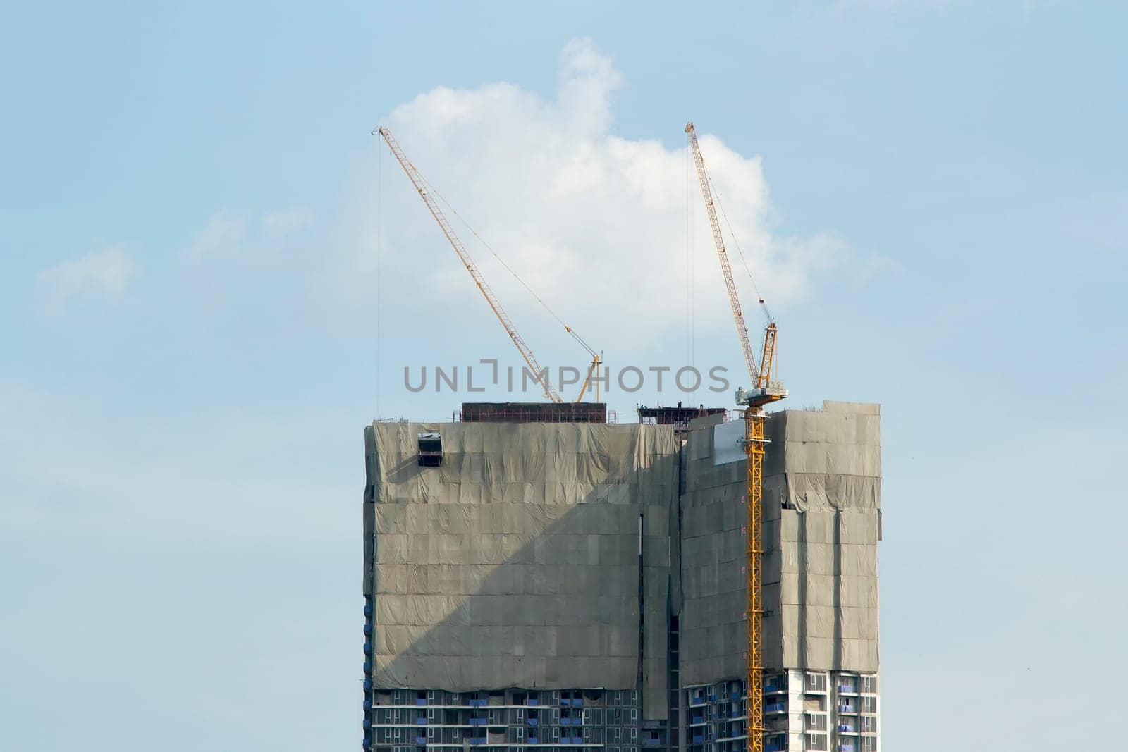 building site with cranes and blue sky