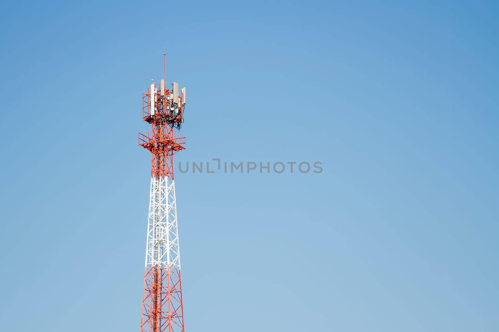 Mobile phone communication tower transmission  signal with blue sky background and antenna