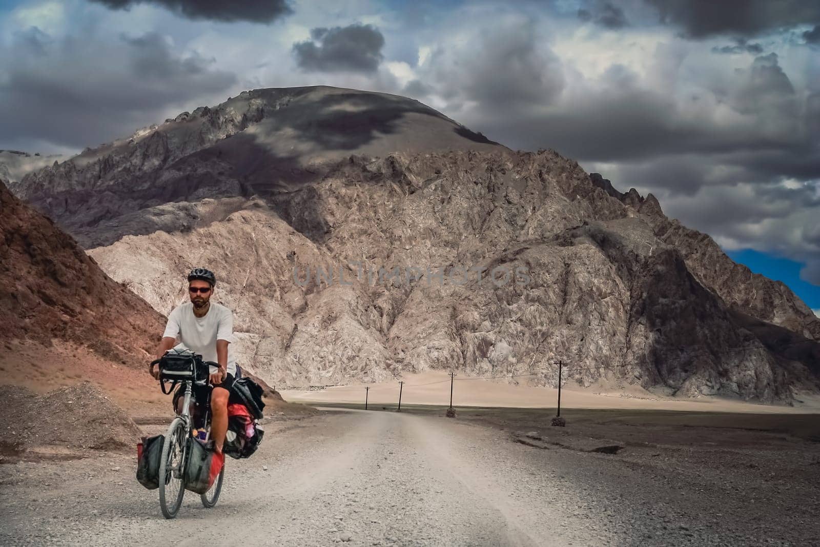 Solo male cycle touring through the stunning remote landscape of Western Tibet