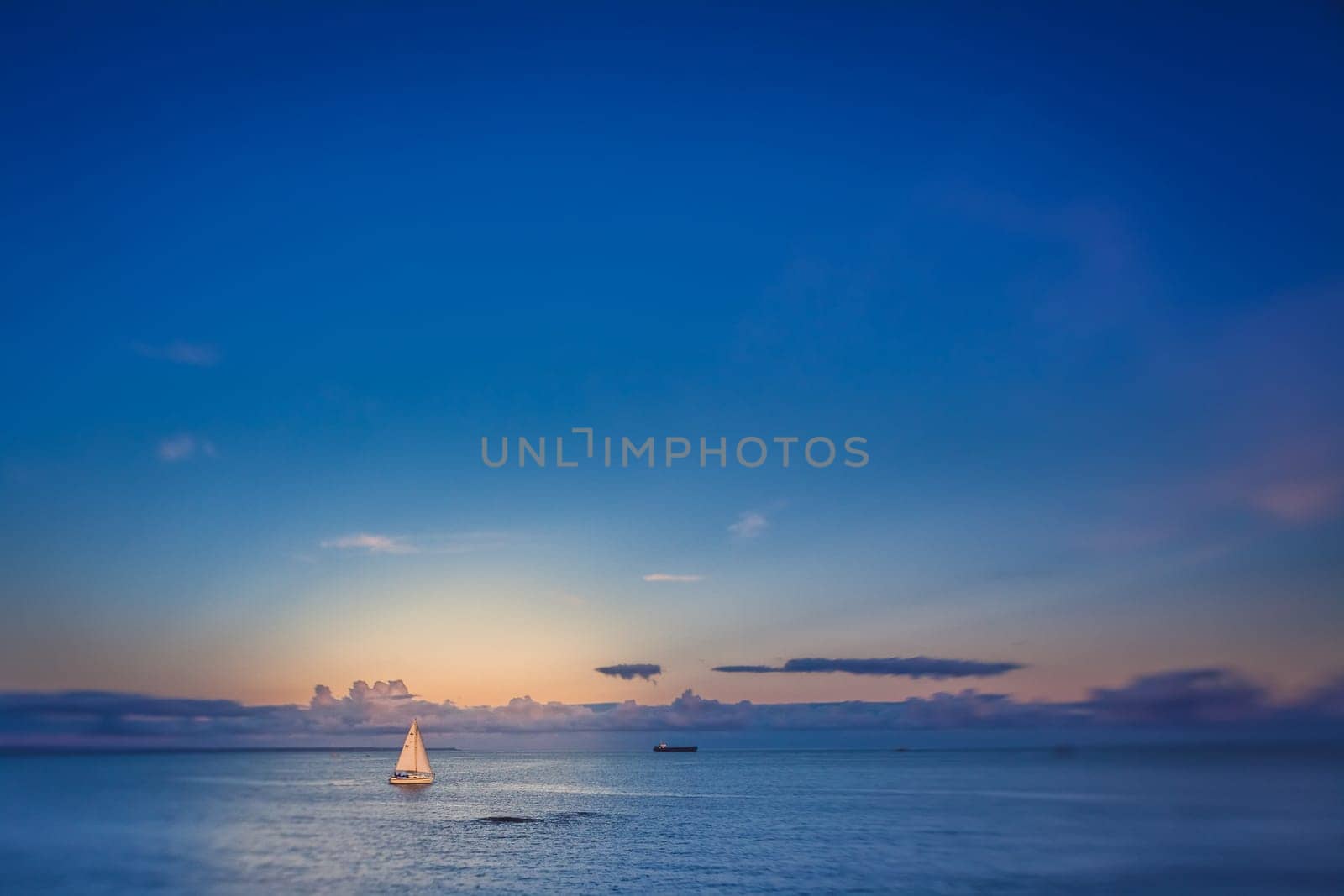 Small sailboat on a calm sea in Penzance, Cornwall, England, UK