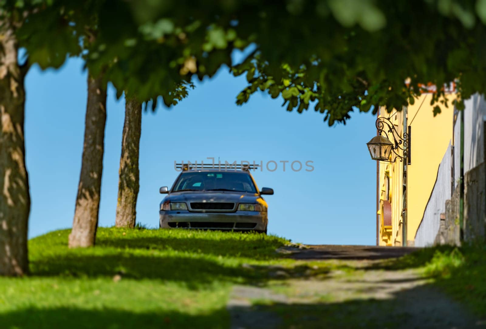 Old car parked near house in street of Alesund, Norway, Scandinavia, Europe