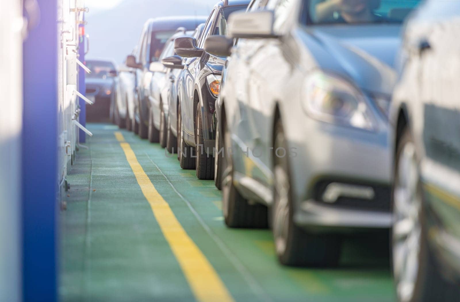 Cars waiting in line on deck of ferry in Norway, Scandinavia, Europe. Water transportation.