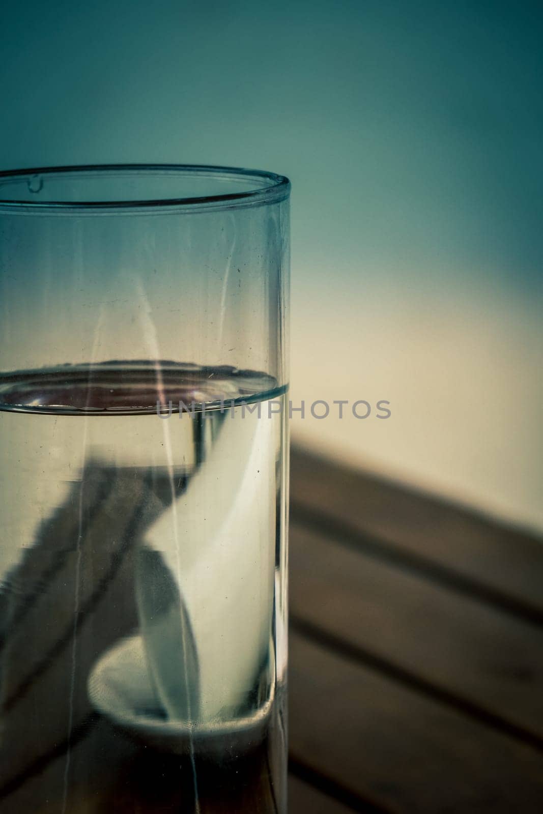 Coffee cup reflected in a glass with water