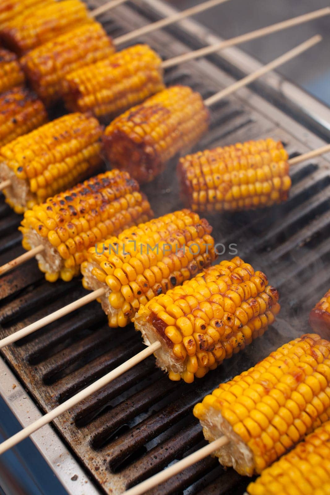 Fresh corn grilled during an outdoors barbecue