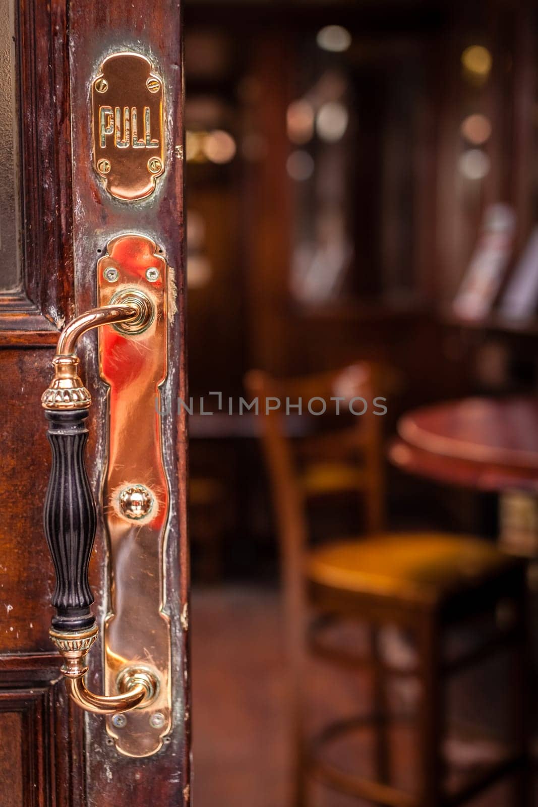 Door handle at the entrance to the traditional English pub in London, UK