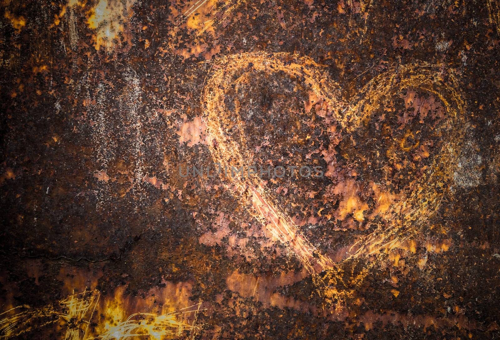 Heart carved on an old and rusty wall
