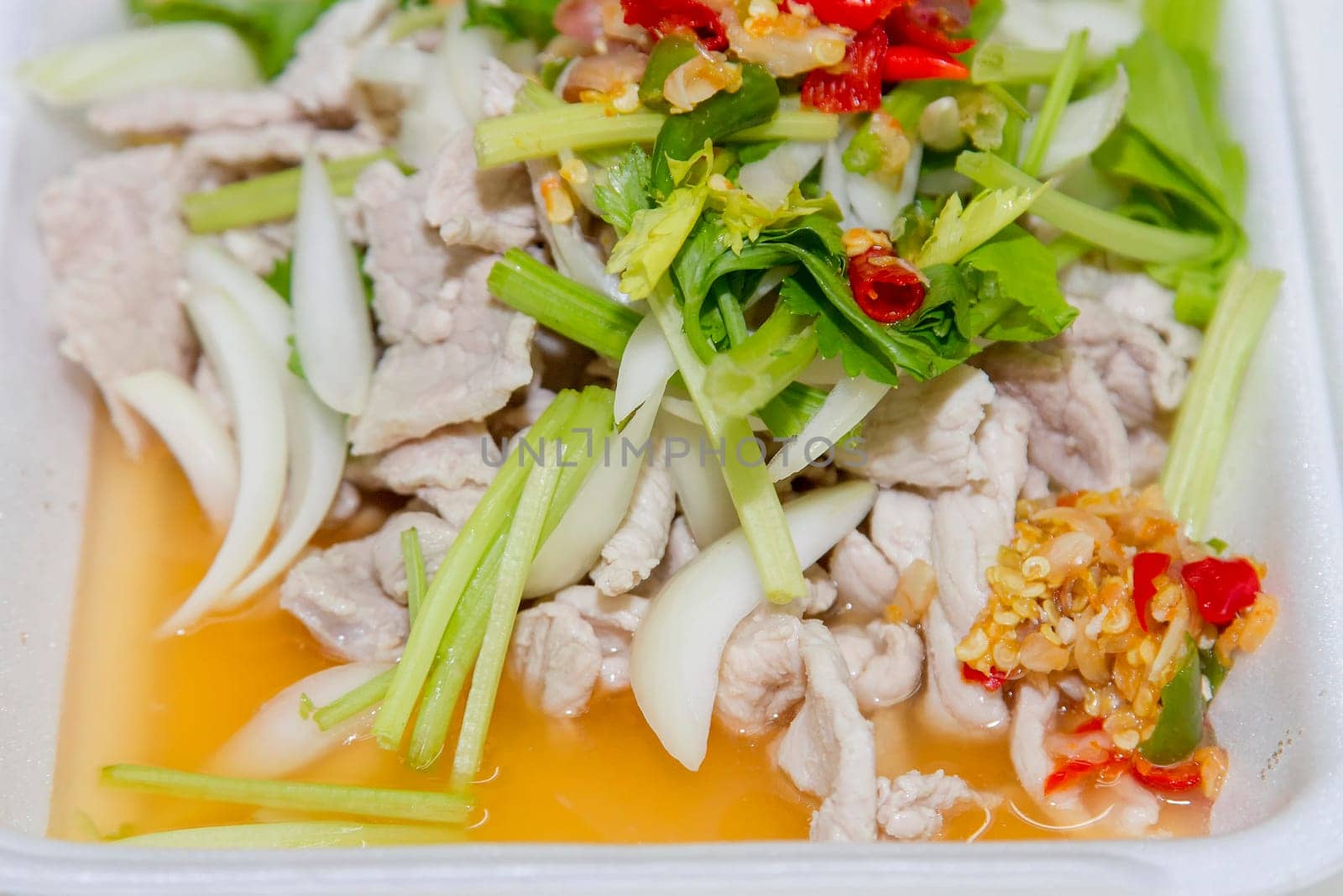 Thai food, lemon pork in white foam box