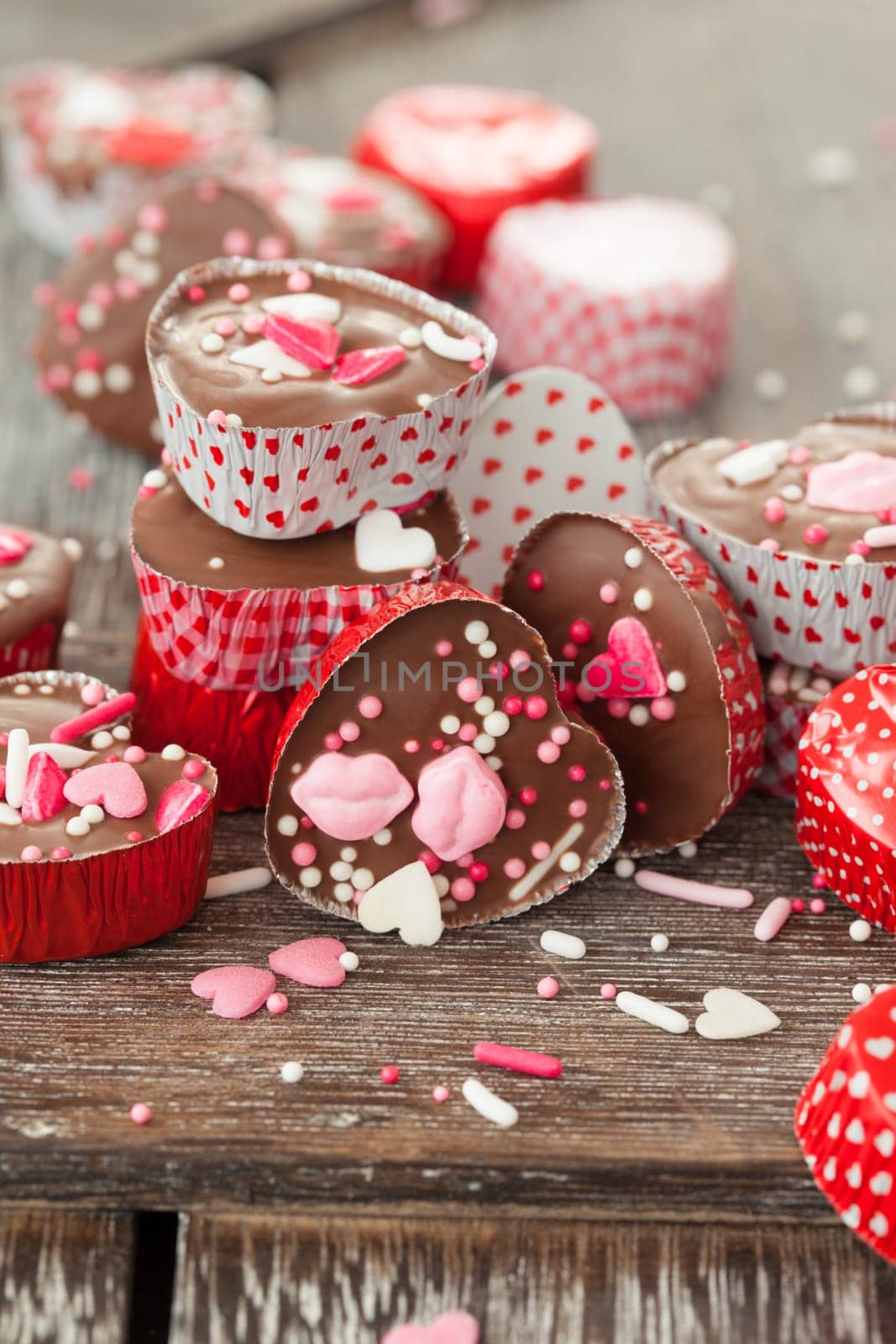 Homemade confectionery with sugar sprinkles in small heart tubes made of aluminium