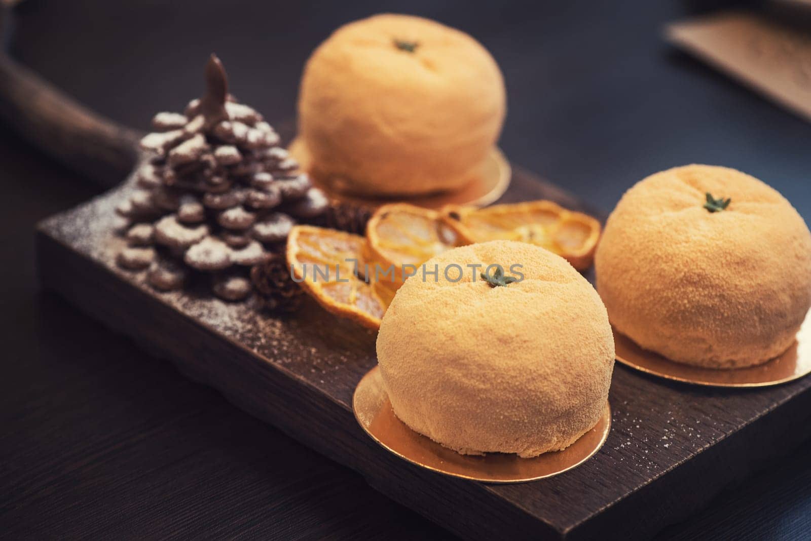 Tasty dessert as orange fruit with chocolate fir-tree for new year holiday