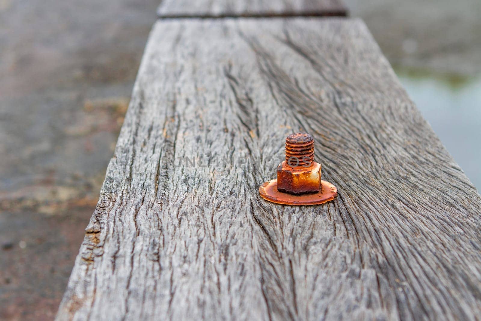 The nut is rust on old wood floor.