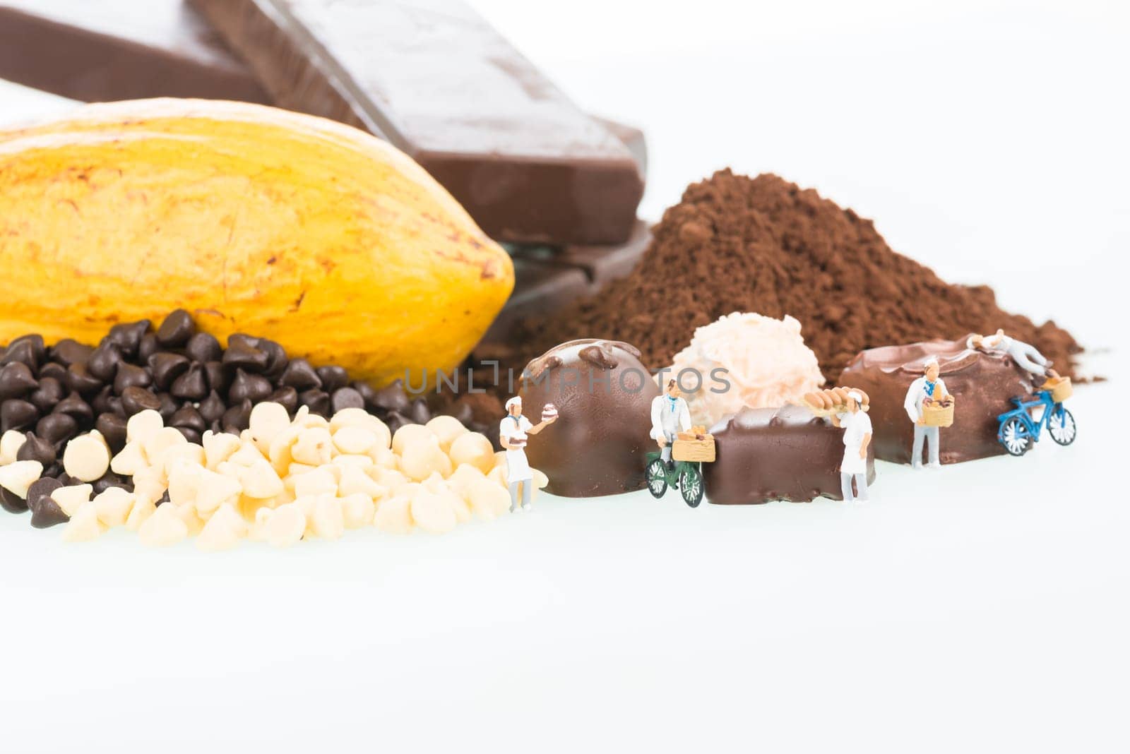 Miniature chefs and chocolate truffles close up