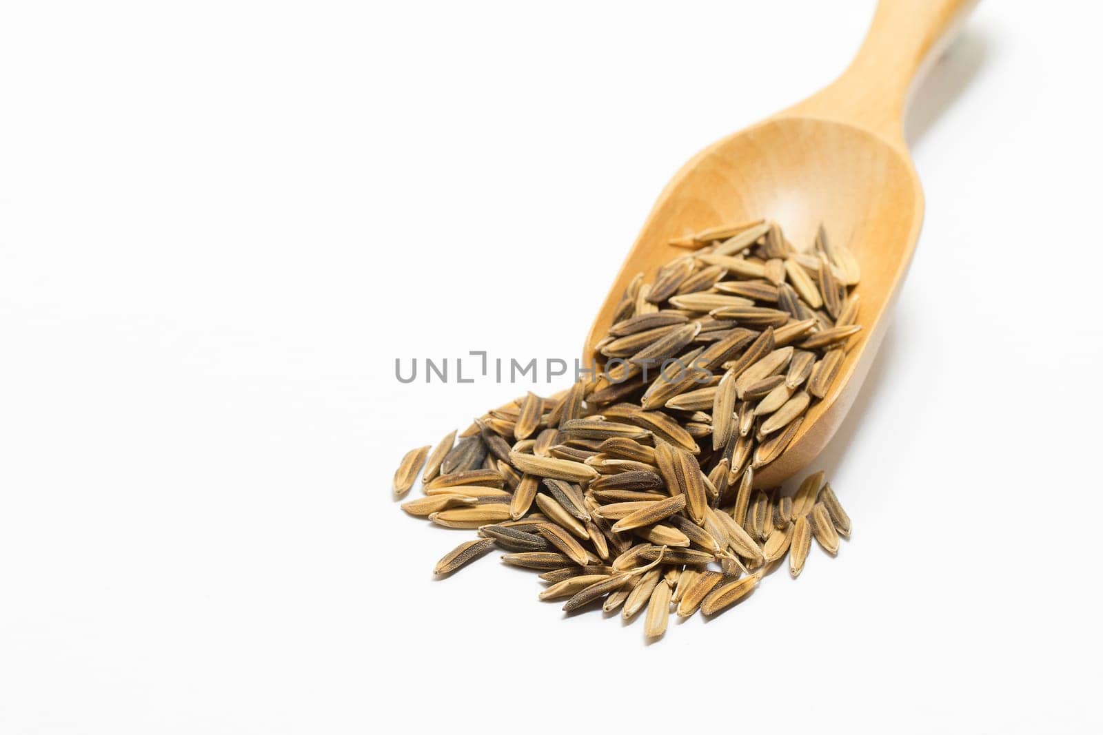 Paddy in the wooden spoon on a white background