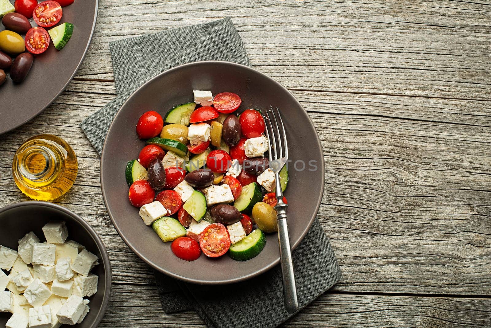 Salad with cheese and fresh vegetables on wooden background. Greek salad.