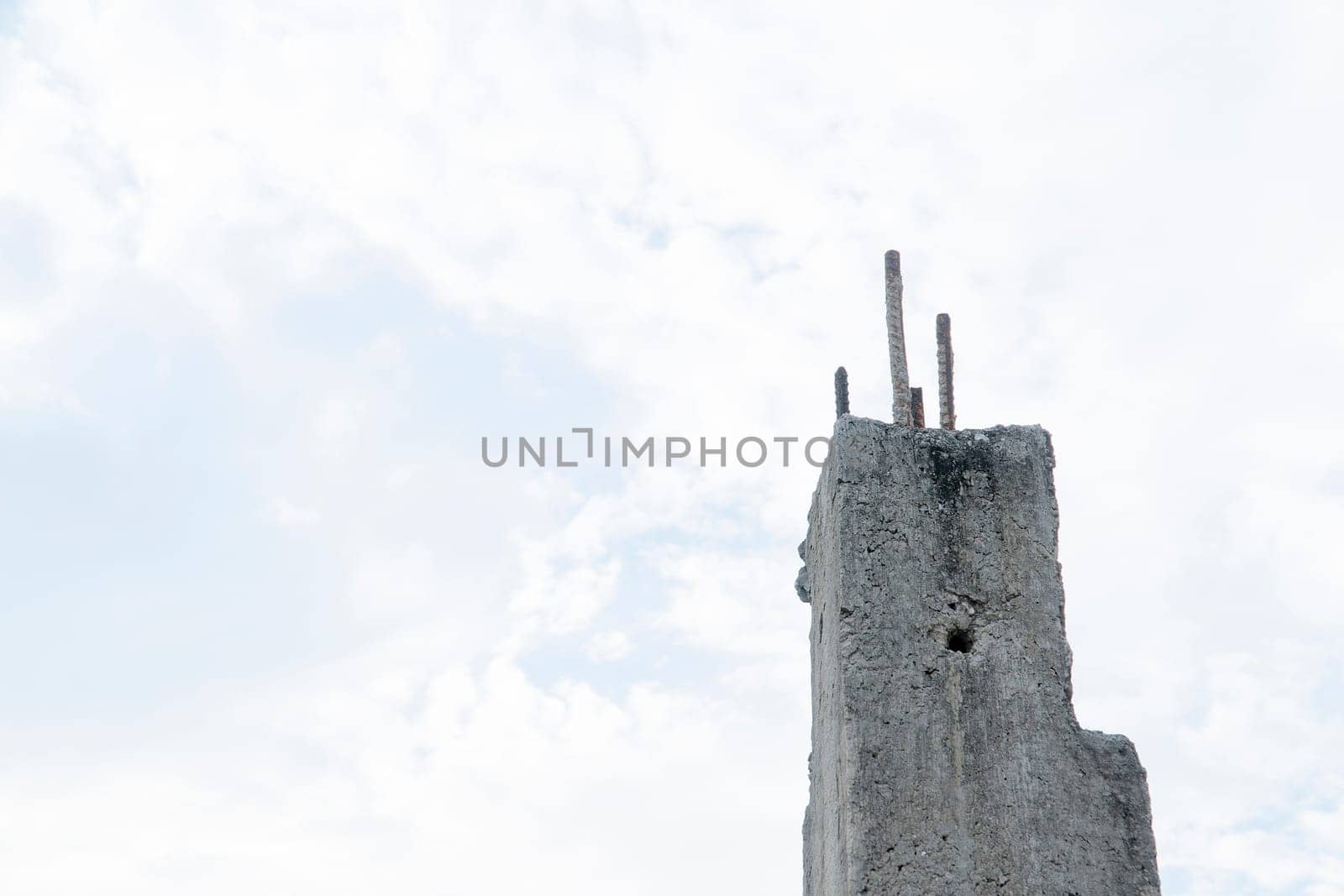 Old cement pillar with white sky background