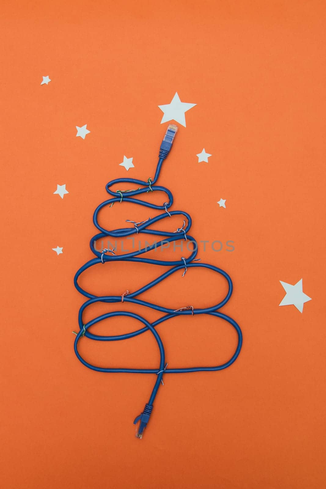 Tech New Year: fir-tree from wires on orange background
