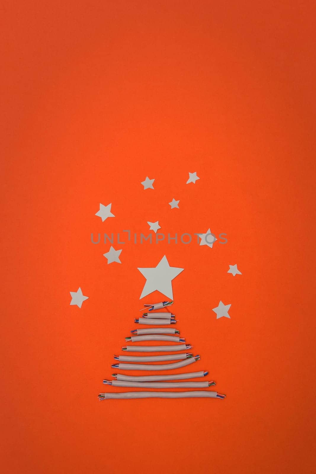 Tech New Year: fir-tree from wires on orange background