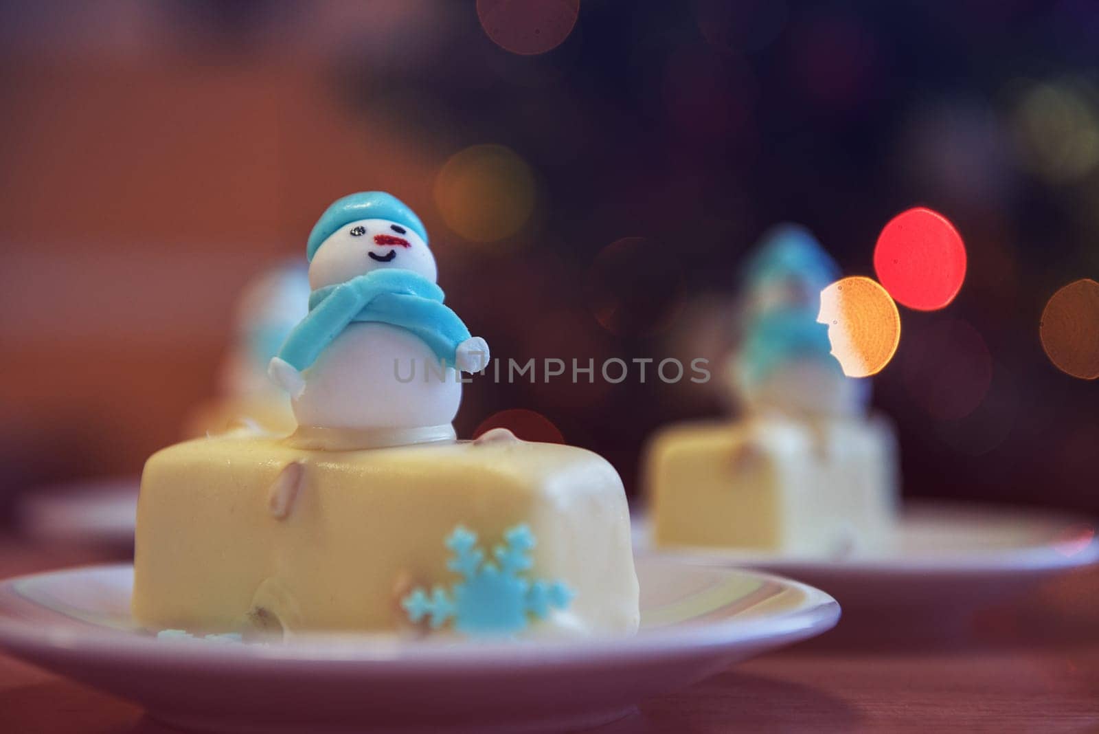 Christmas dessert with snowman on lights bokeh background