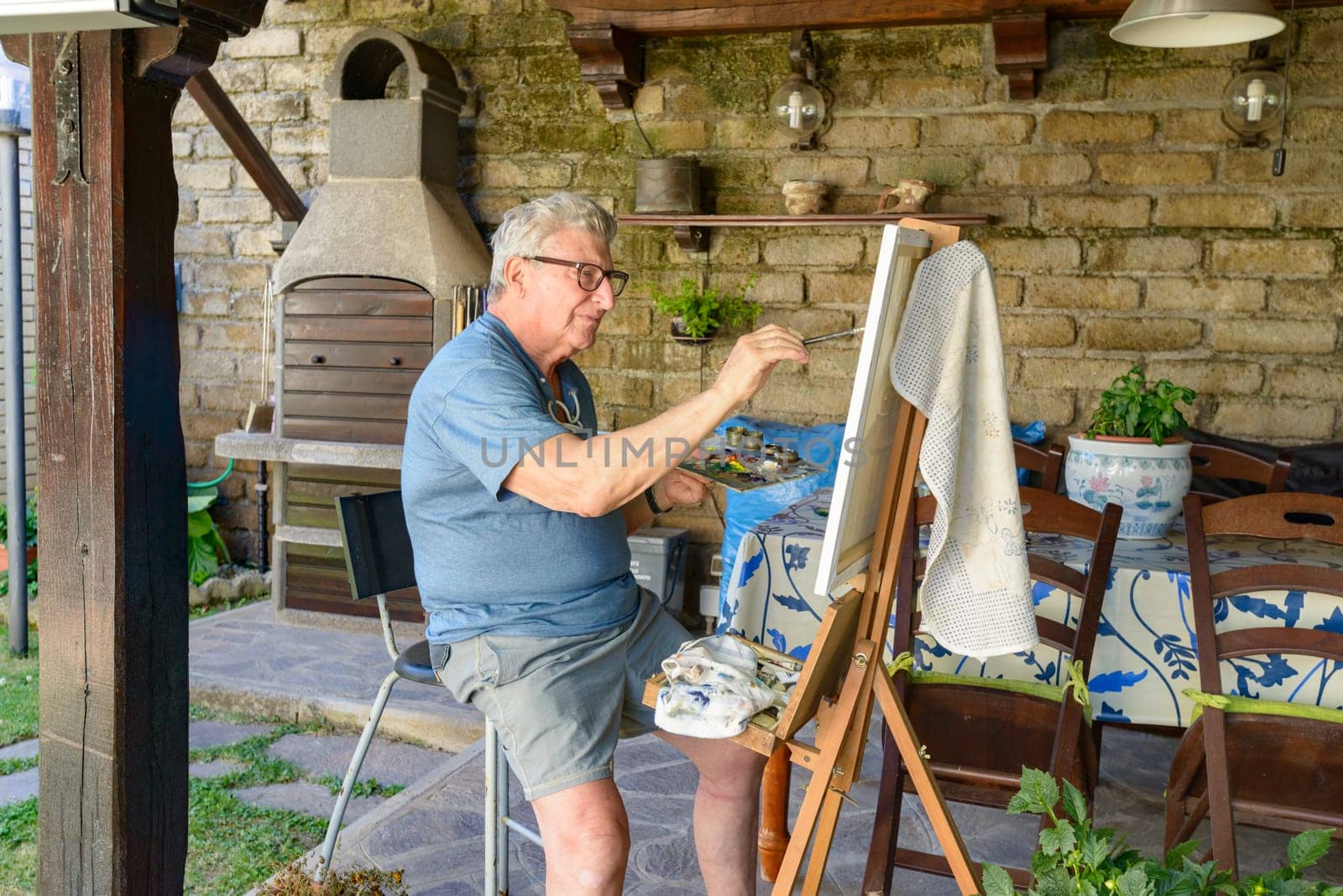 Senior Man painting a picture with oil colors