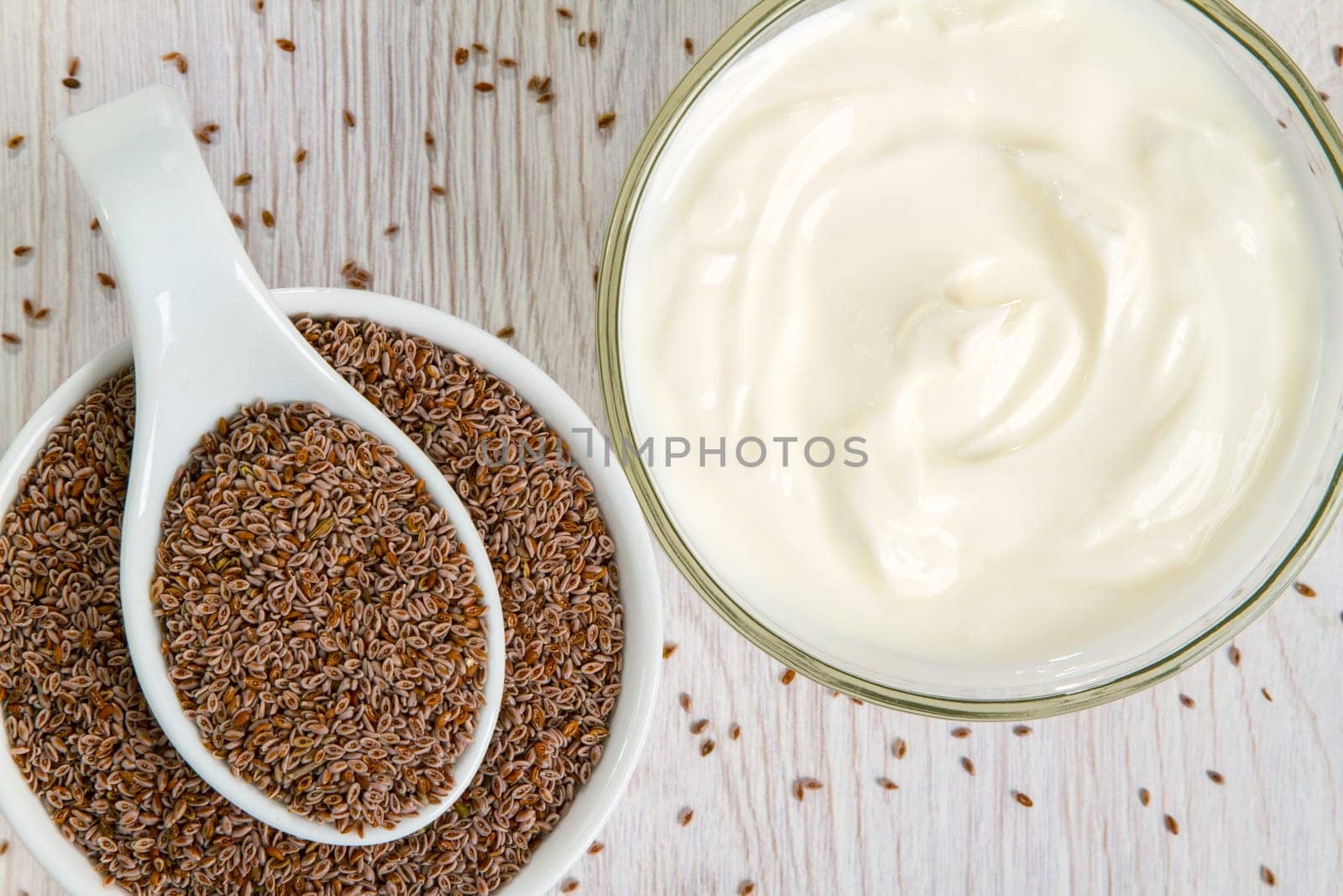 Indian psyllium seeds in detail with natural yogurt