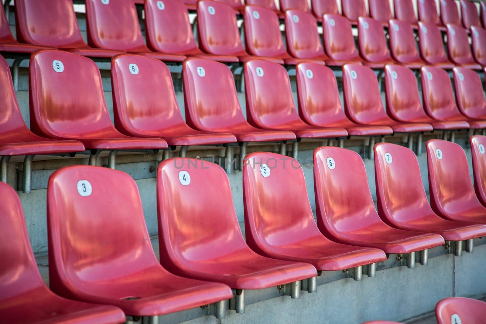 Red rows of seats in detail in a stadium