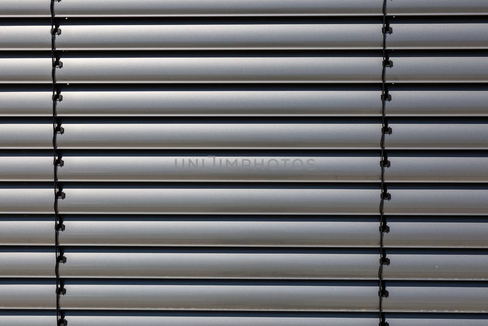 Silver-coloured blinds in detail
