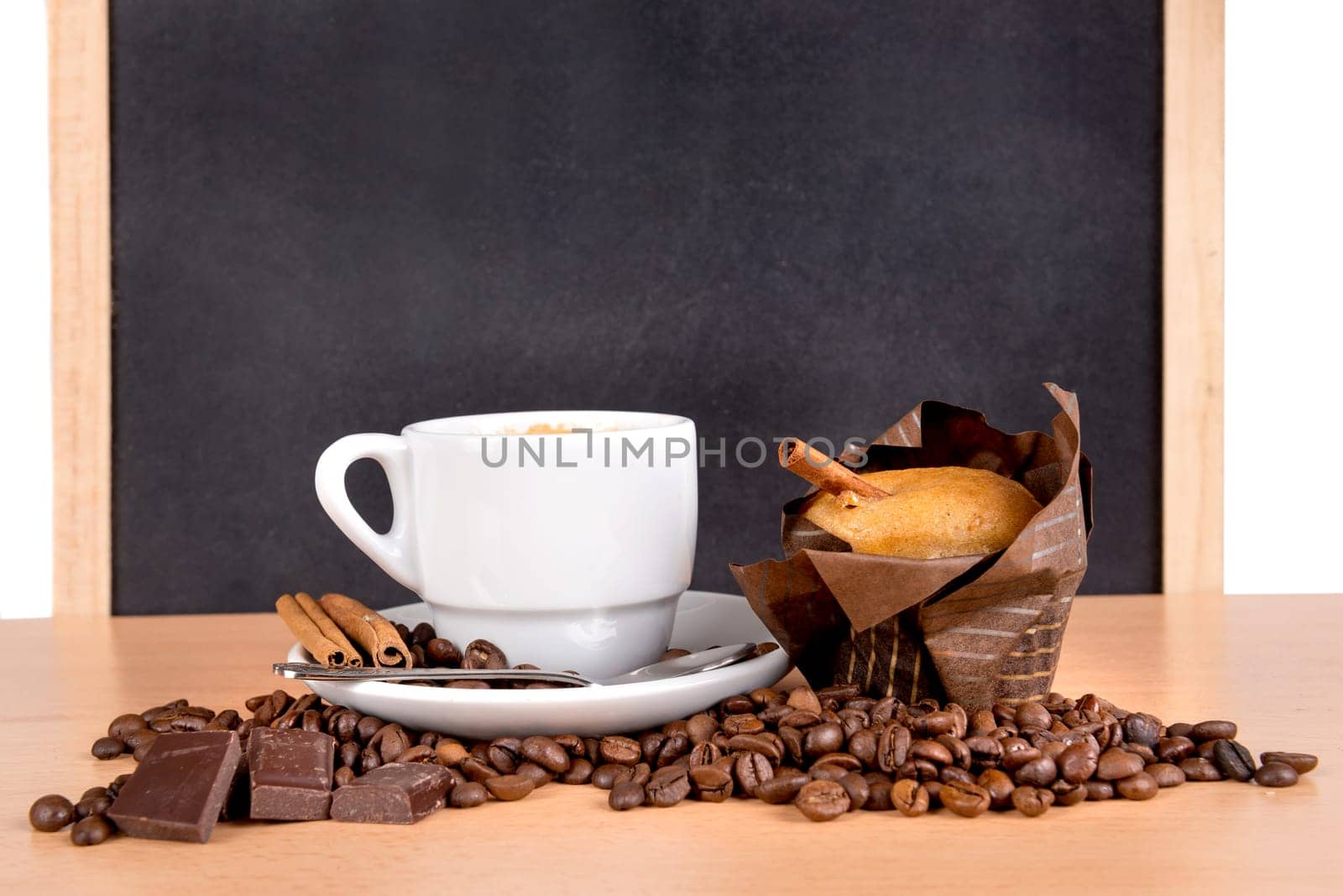 coffee cup with coffee beans, chocolate and muffin