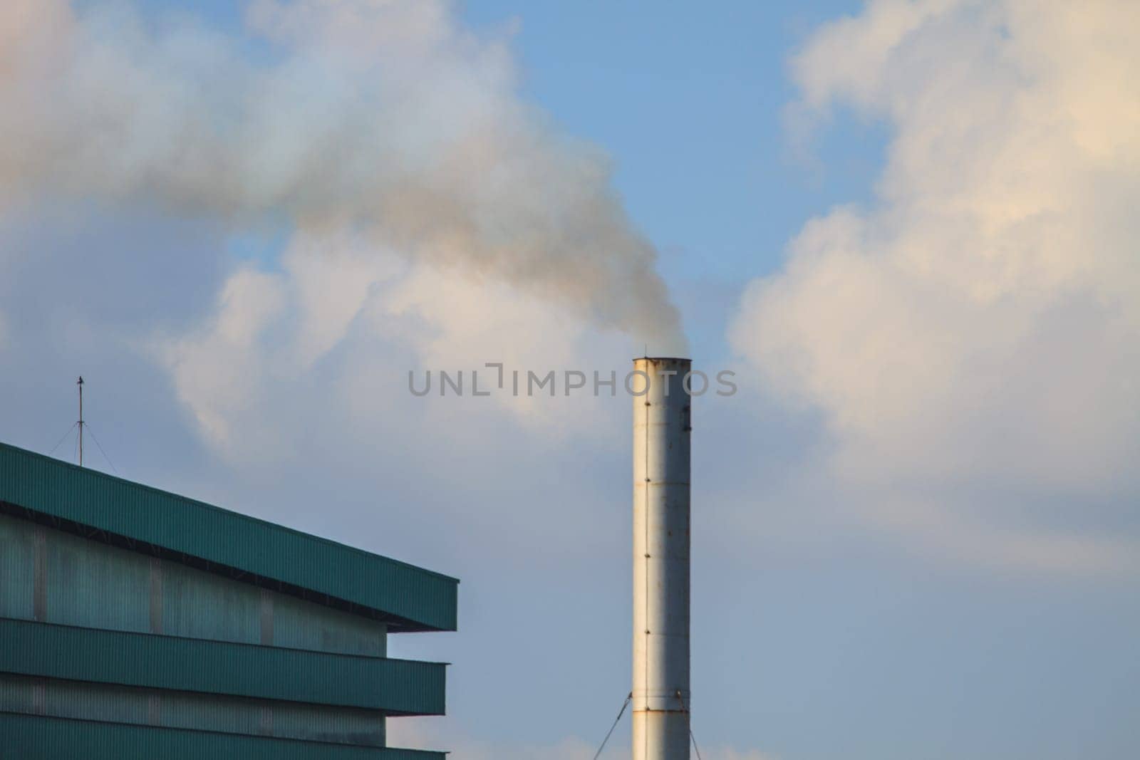 Industrial plant factory with smoking chimneys on sky