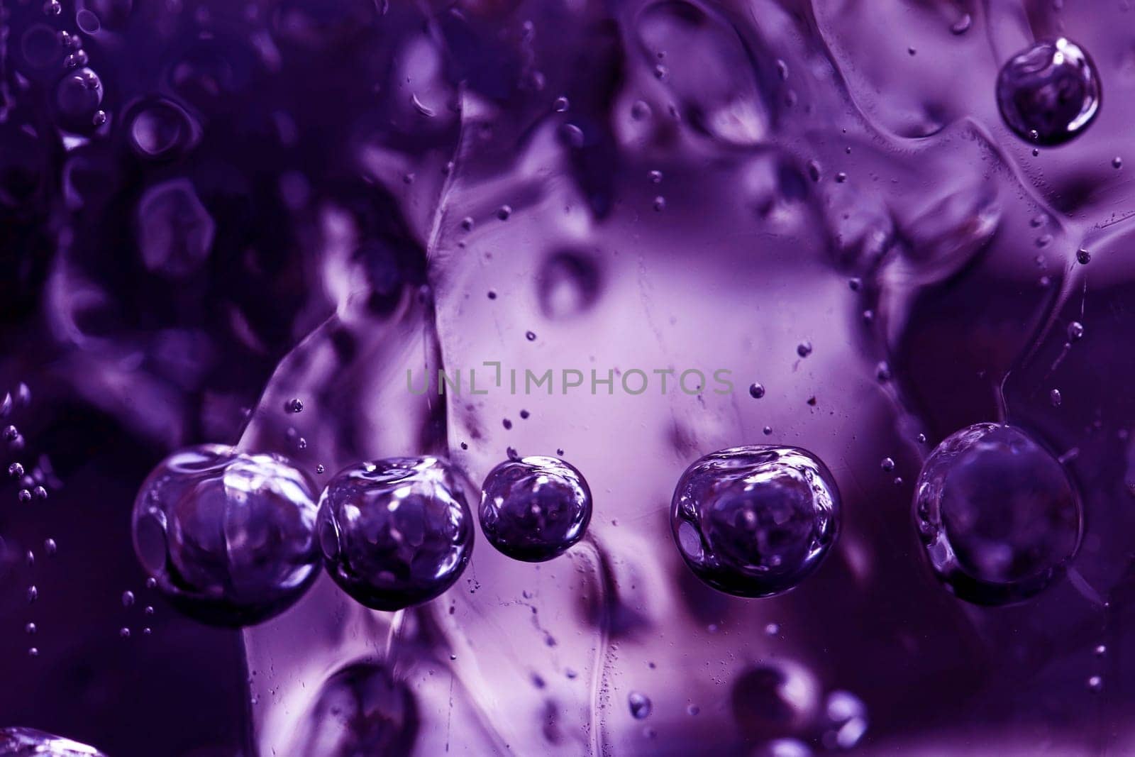 Close-up of frozen air bubbles in a chunk of ice in ultra violet. Air bubbles in the ice