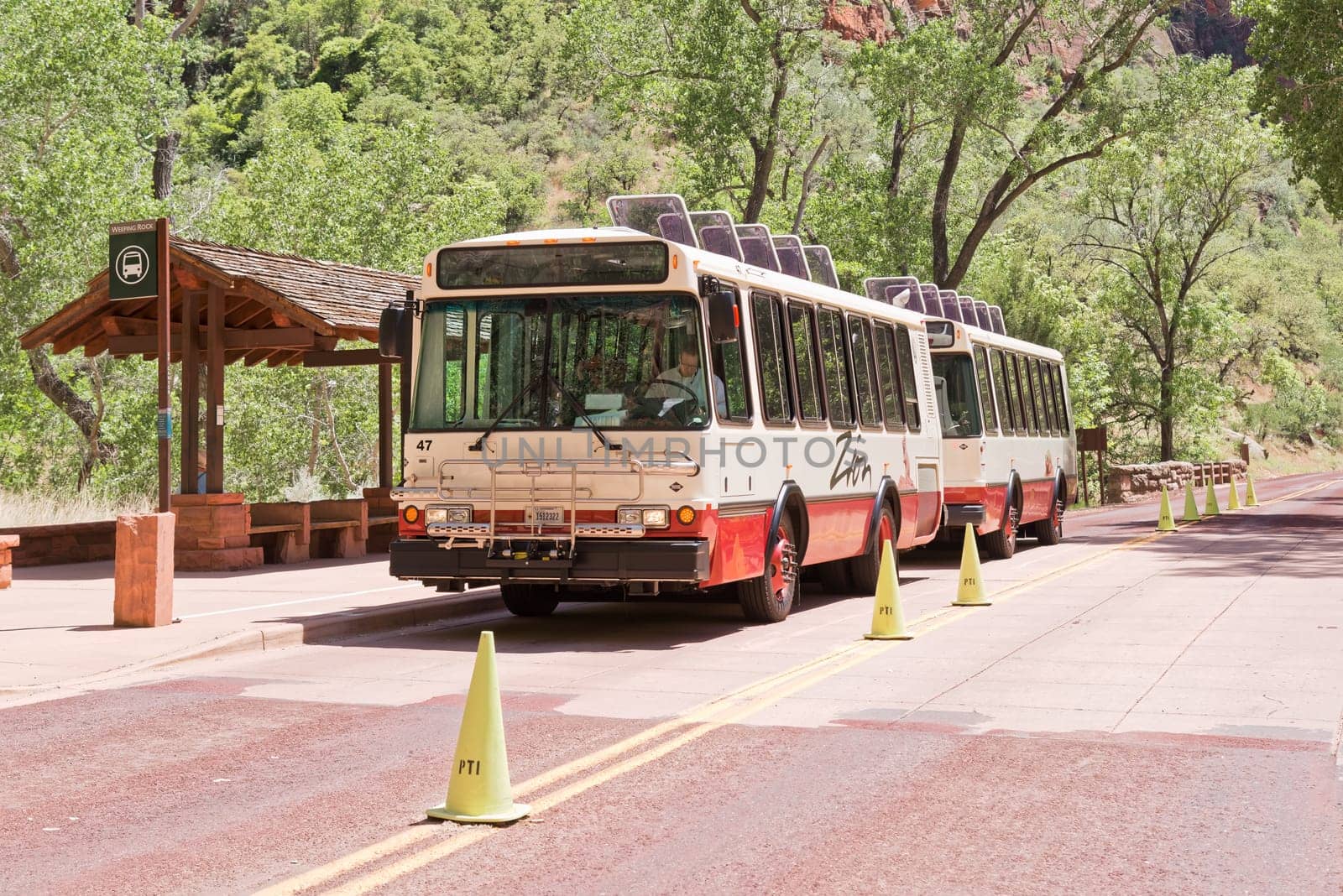 Springdale, Utah, USA - June 03, 2015: Bus driver waits for passengers to be transported through Zion National Park.