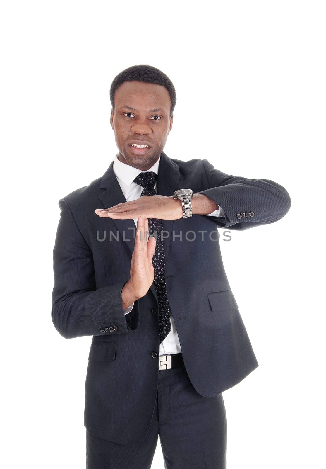 A tall African American business man standing in a suit and signals.with his hands he wand's to talk, isolated for white background.