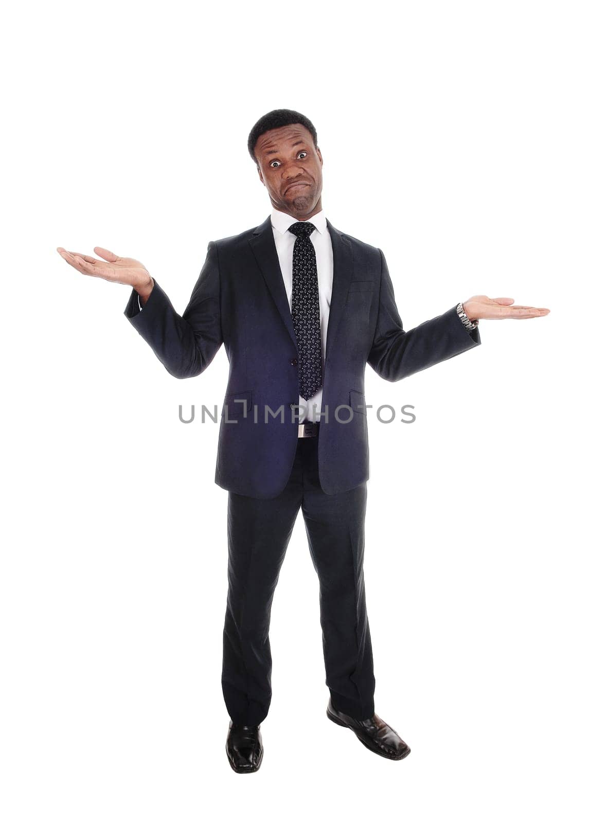 A handsome tall African American man standing in a suit with .outchteched hands is not sure, isolated for white background.