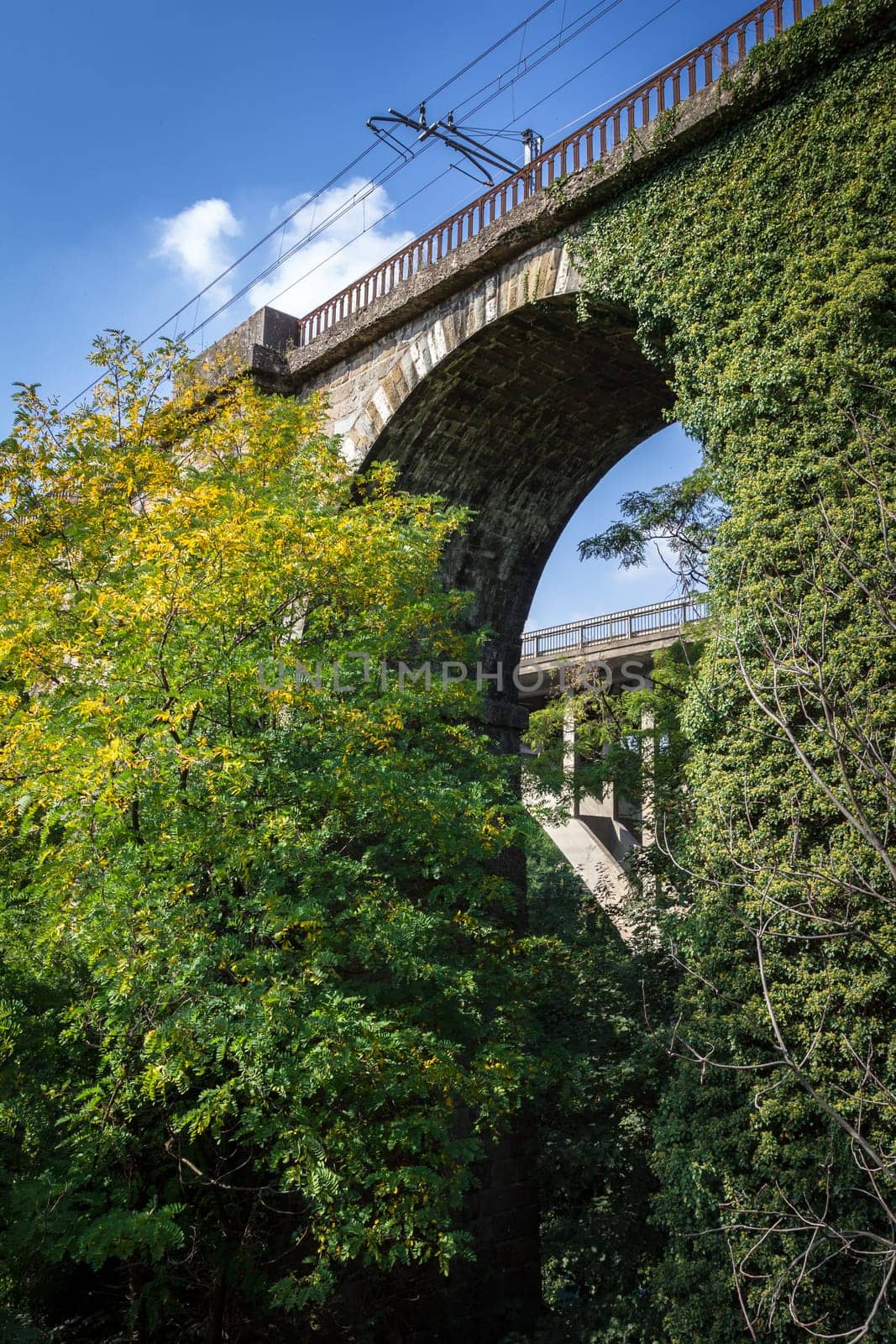 Old railroad bridge with stone arch