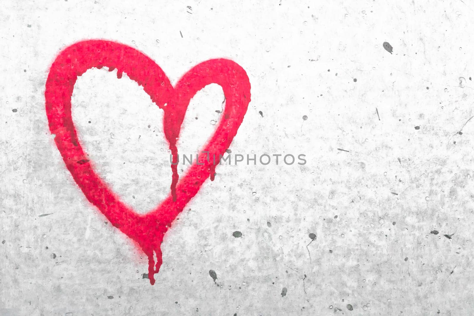 Red heart symbol. Grungy wall background. Fall in love and Valentine's day concept.