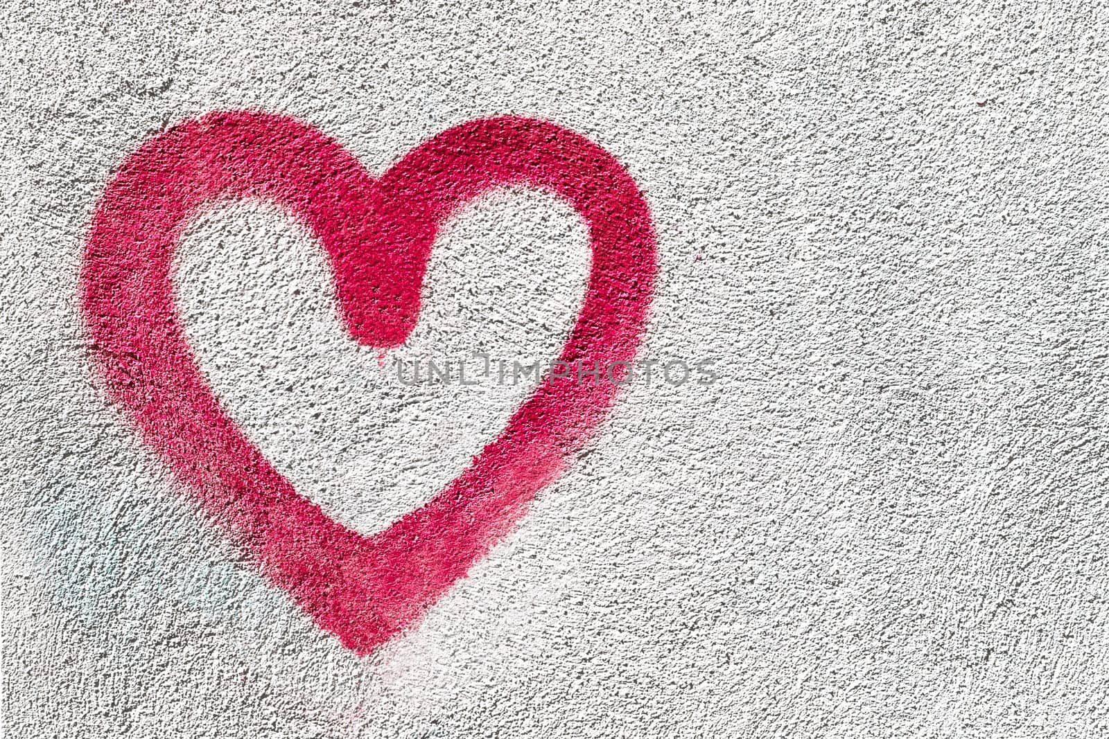 Red heart symbol. Grungy wall background. Fall in love and Valentine's day concept.
