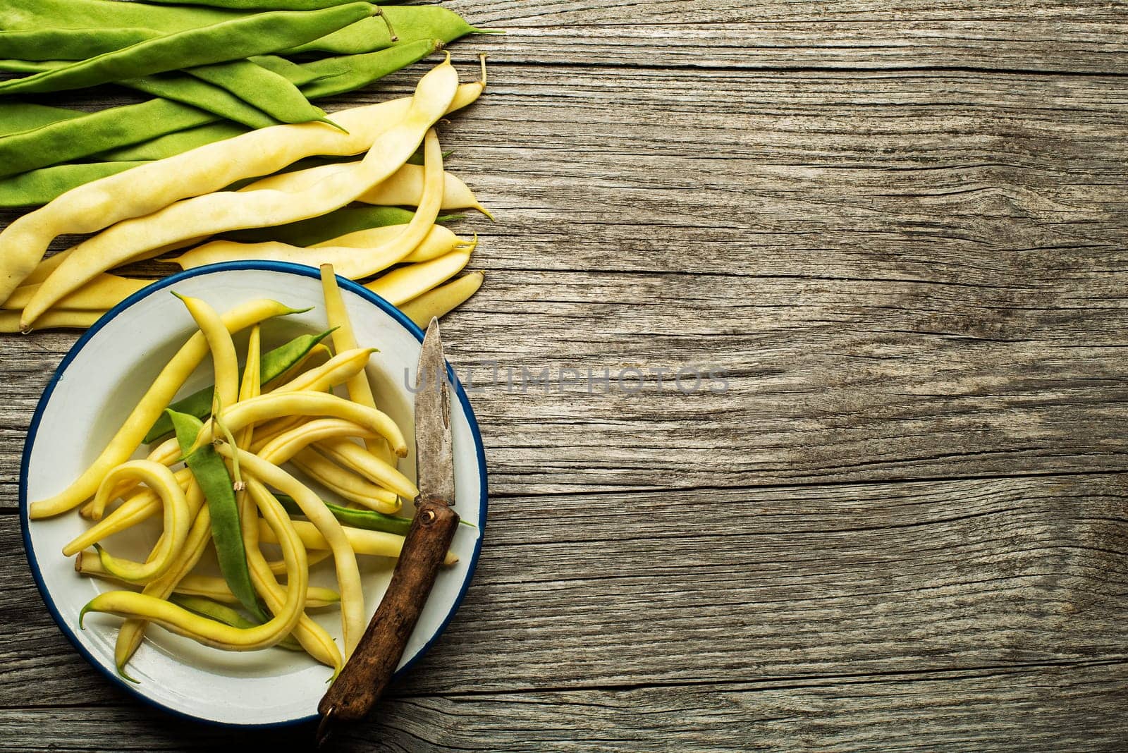 Fresh green and yellow beans on wooden table